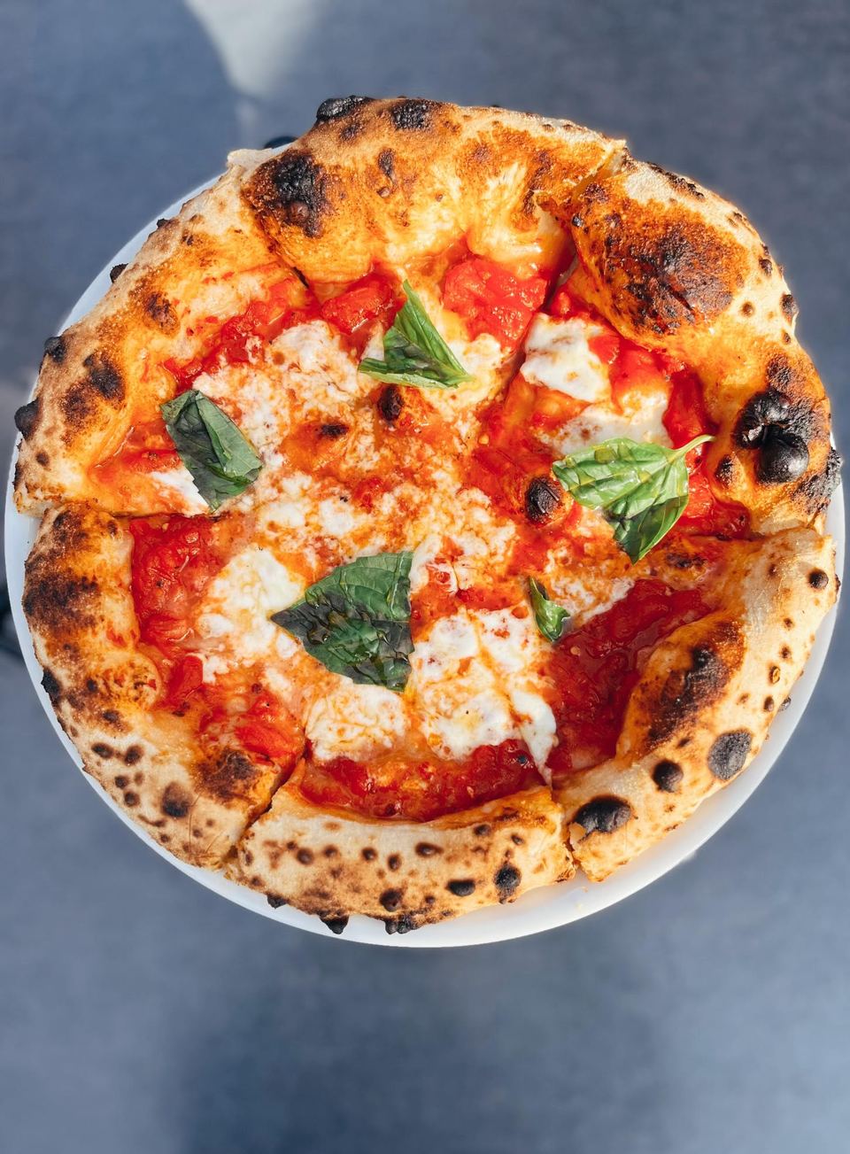 A pizza going into the forno